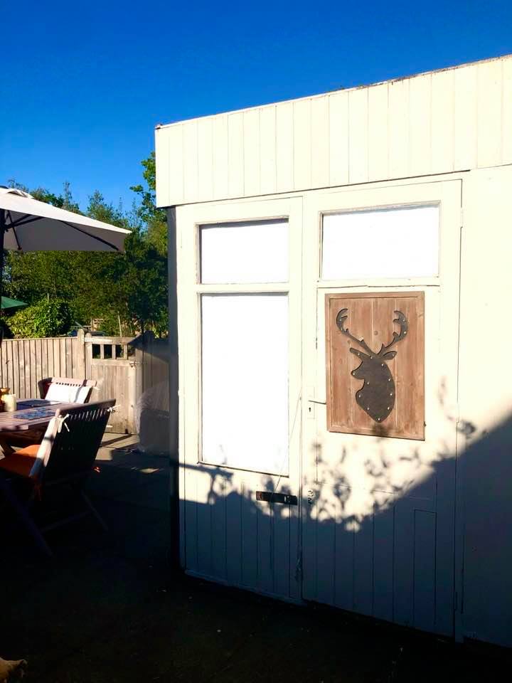 "Recycled Patio Blog" after picture of painted shed by Emma Mullender
