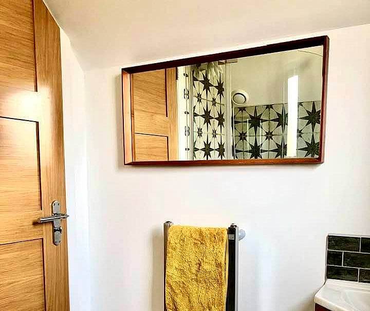 "Guest Shower Room interior styling" Retro teak mirror and heated towel rail by Emma Mullender
