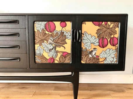 "Upcyc;led Retro Sideboard" before Frutto Proibito wallpaper. Door detail by Emma Mullender