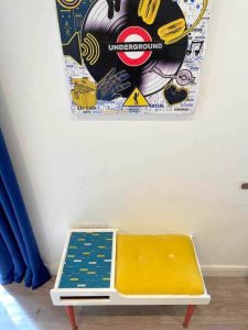 "Retro telephone table in room with underground dance print" by Emma Mullender