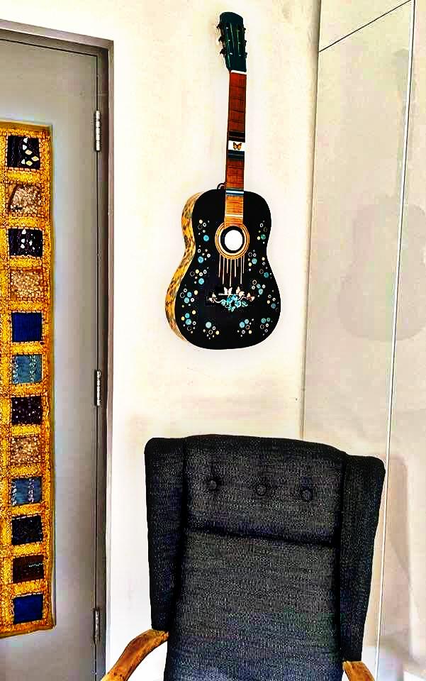 "Guitar LED Lamp Assemblage in room" by Emma Mullender